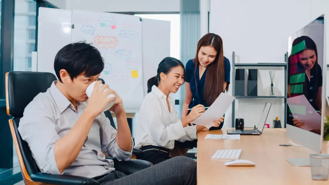 Professional colleagues collaborating with business software during an office meeting